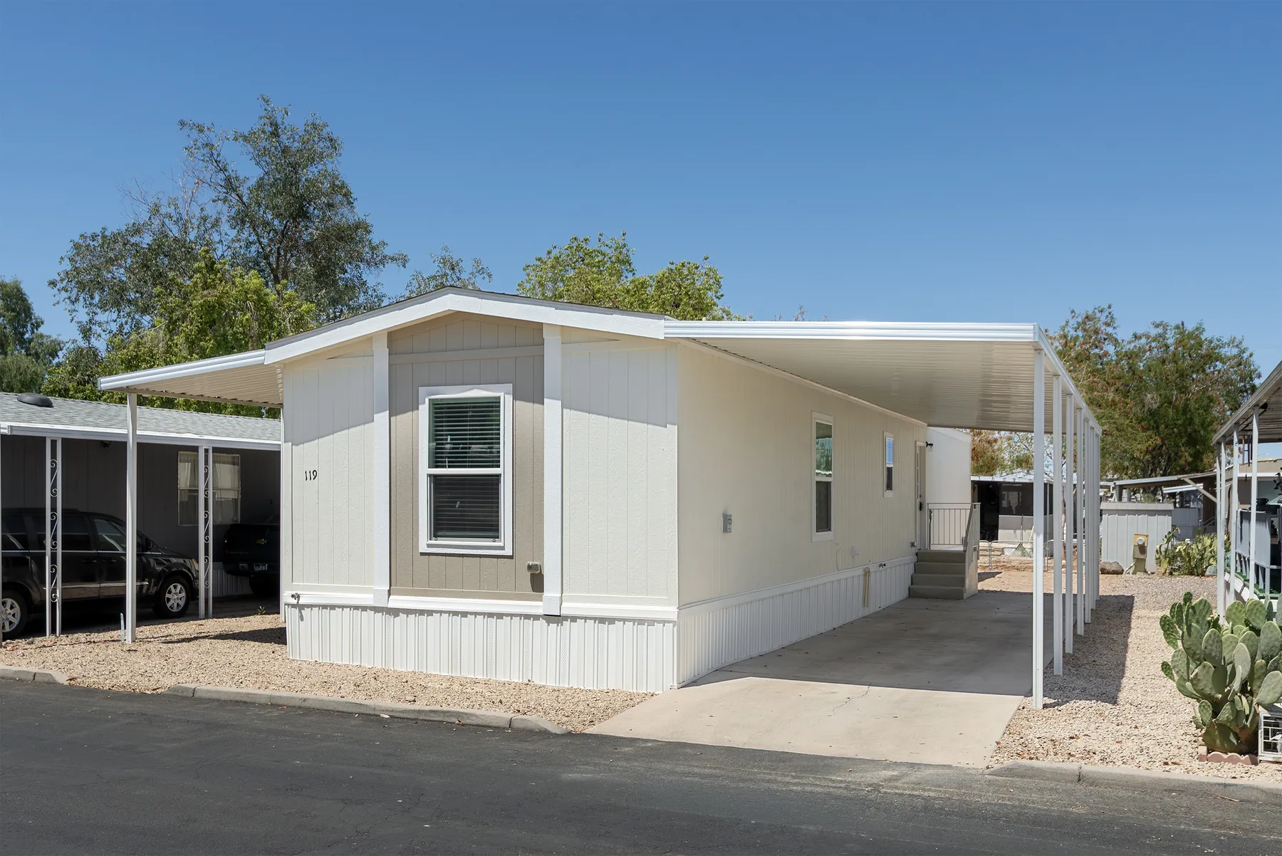 Front corner of home #119 with carport and driveway