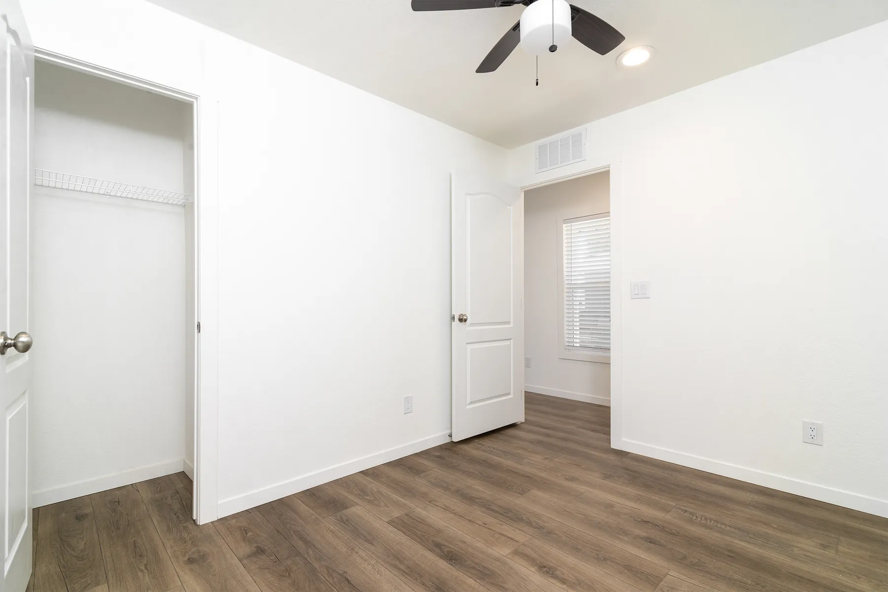 Bedroom with closet and door to the hall