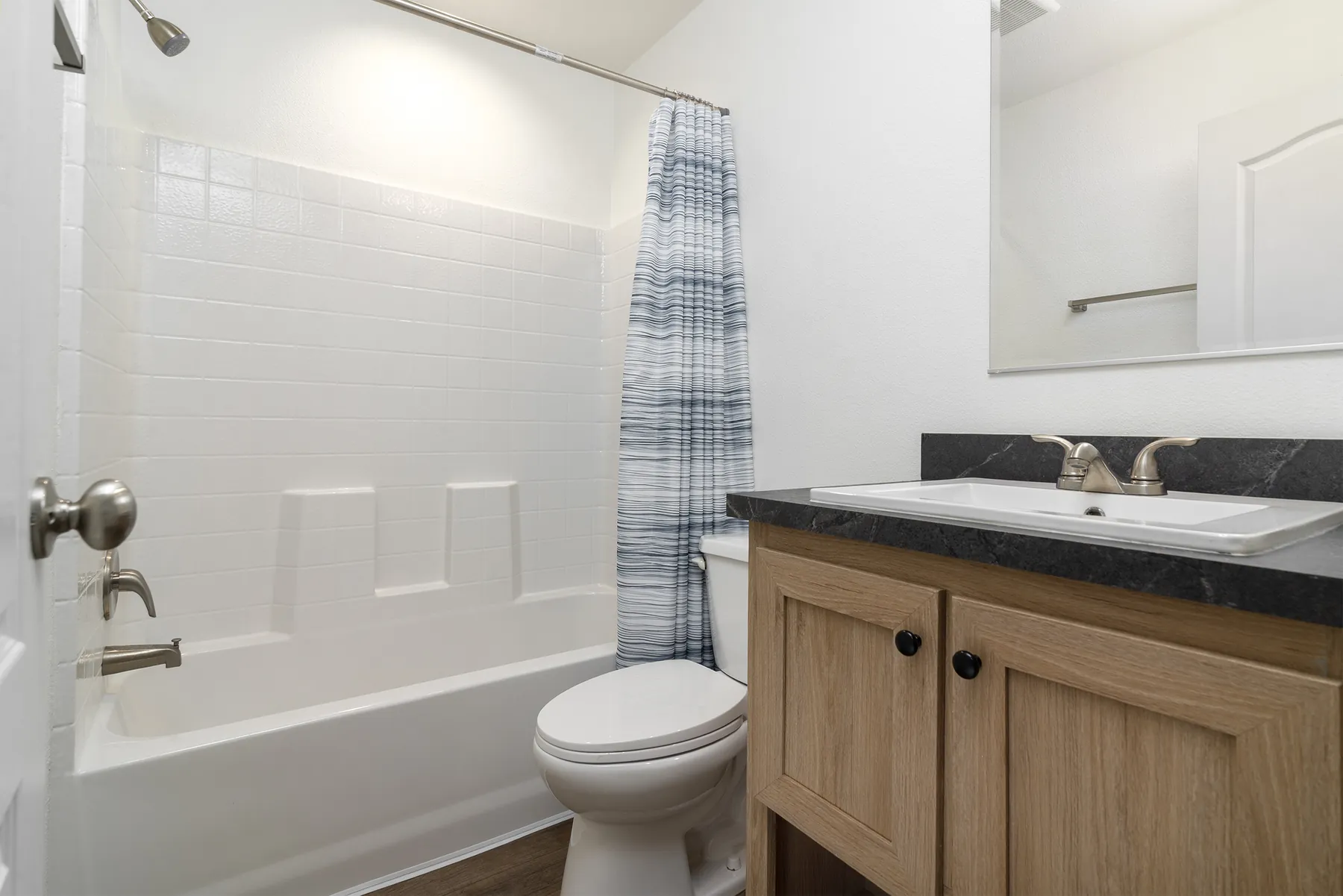 Guest bathroom with tub shower and vanity