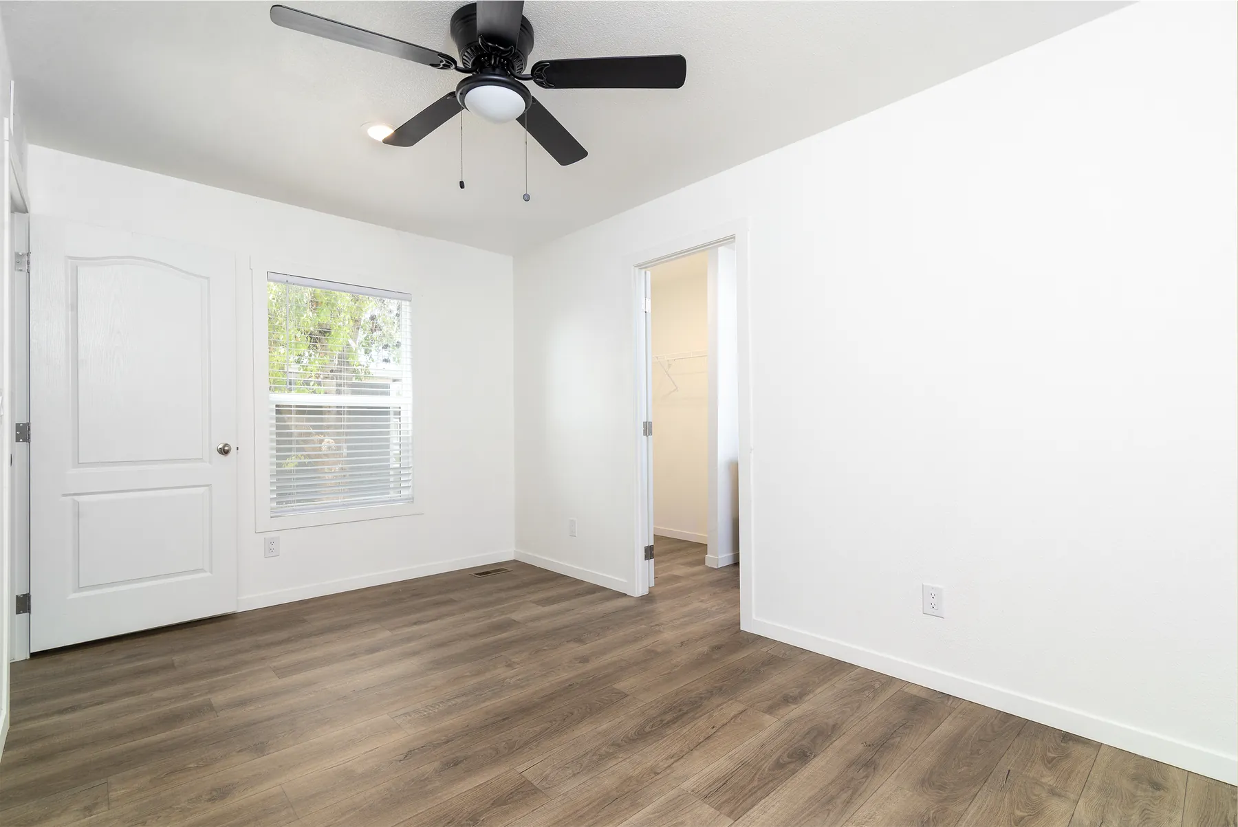 Primary bedroom with walk-in closet doorway