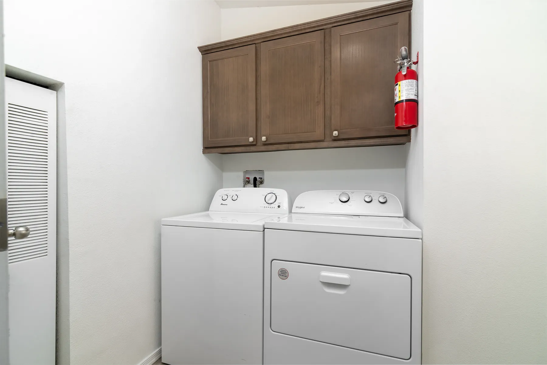 Laundry room with washer, dryer and cabinets
