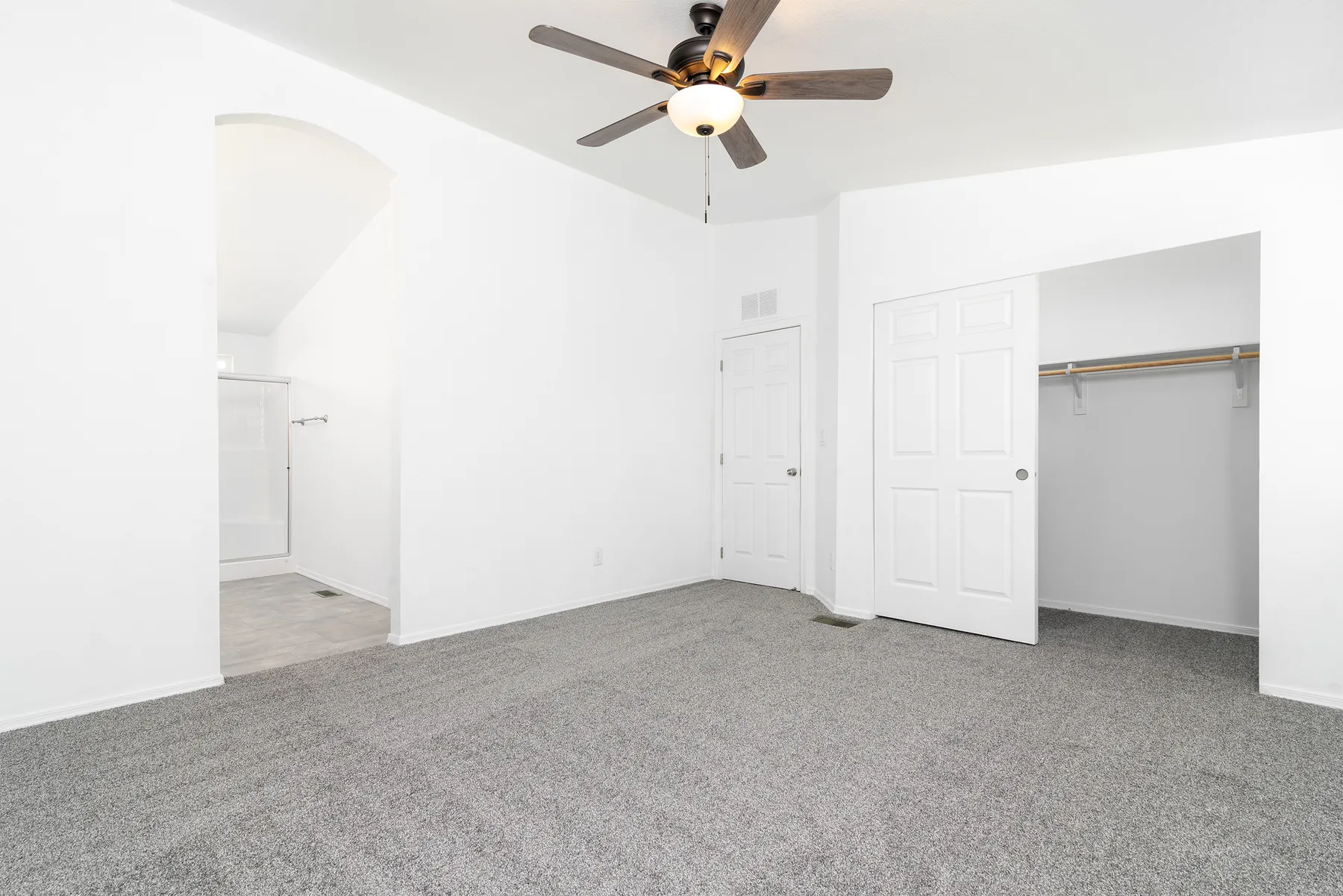 Primary bedroom with closet and arch to the en suite
