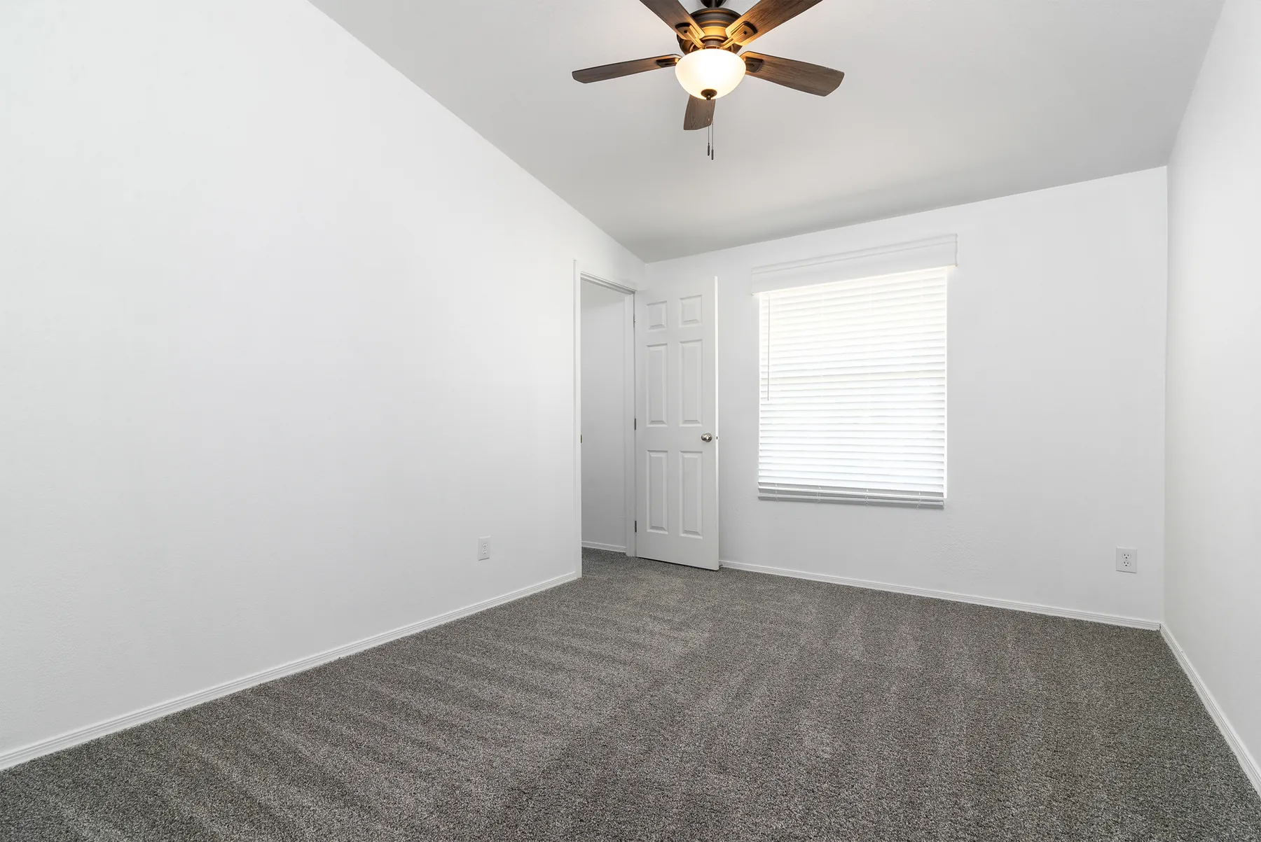 Secondary bedroom with ceiling fan and window