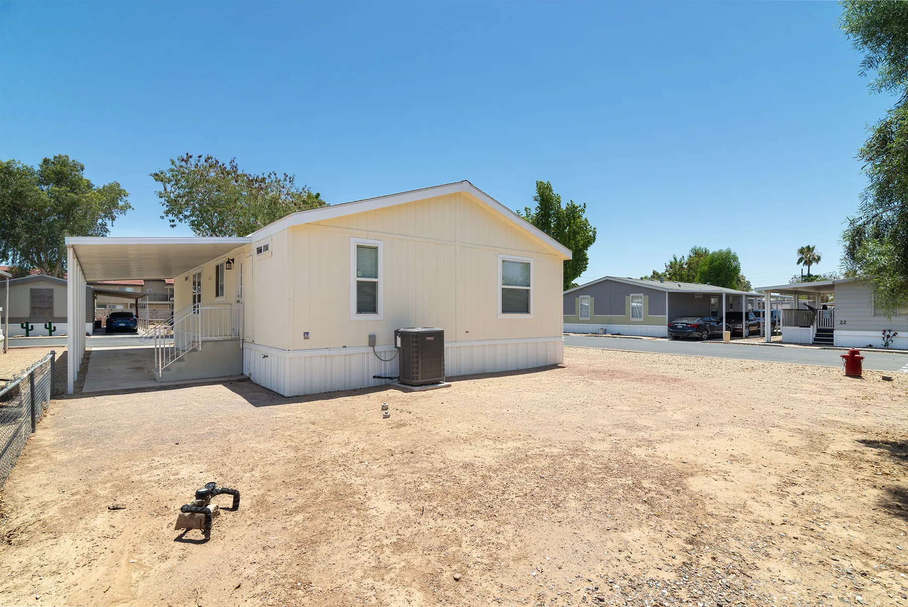 Rear of the home with A/C unit and the open corner lot